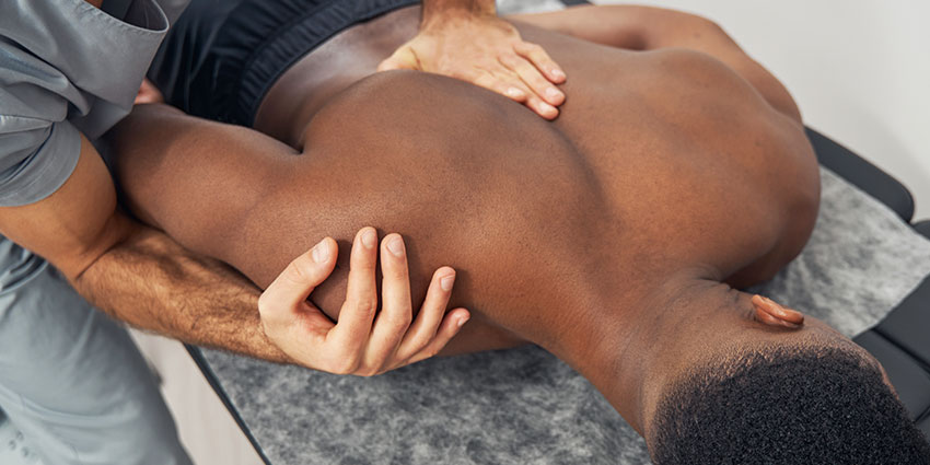 Monterey Park auto accident forms for chiropractor adjusting patient's shoulder to relieve pain